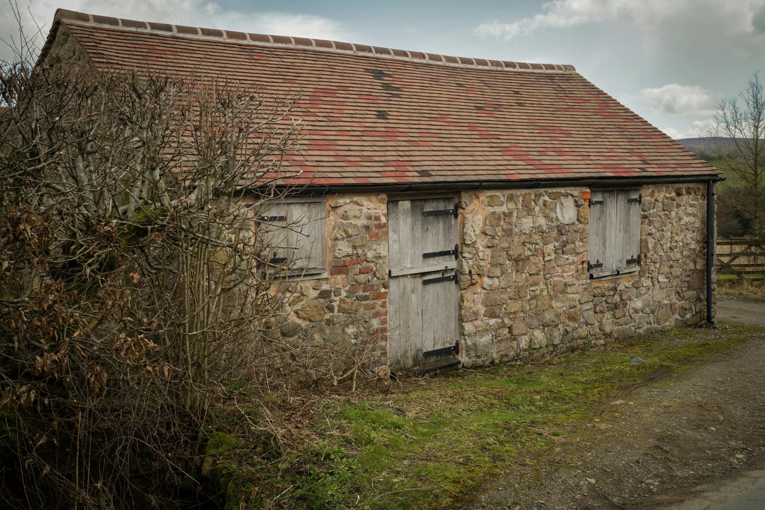 Charming abandoned stone barn in the Shrewsbury countryside, capturing a vintage rural vibe.